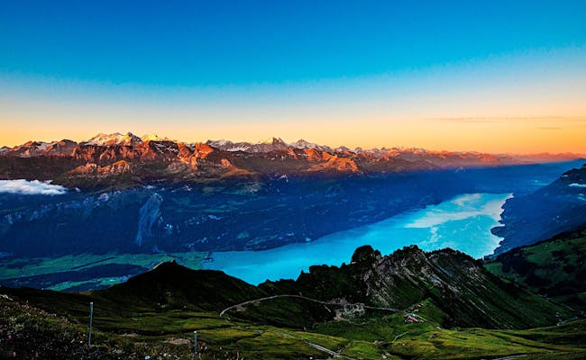 Sunrise over Lake Brienz with mountains in the background.