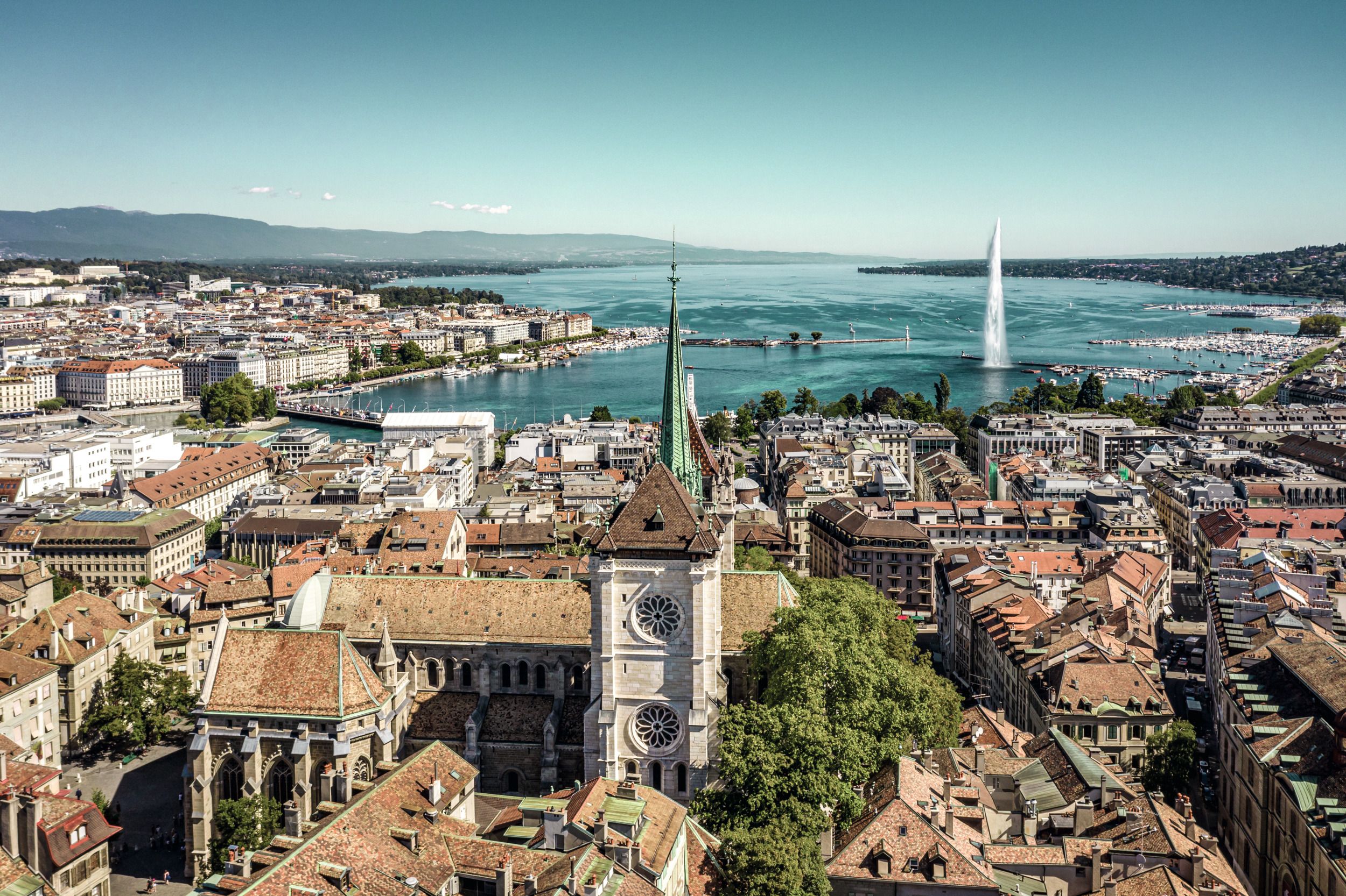 Geneva: View of Lake Geneva, the church, and the city with impressive architecture.