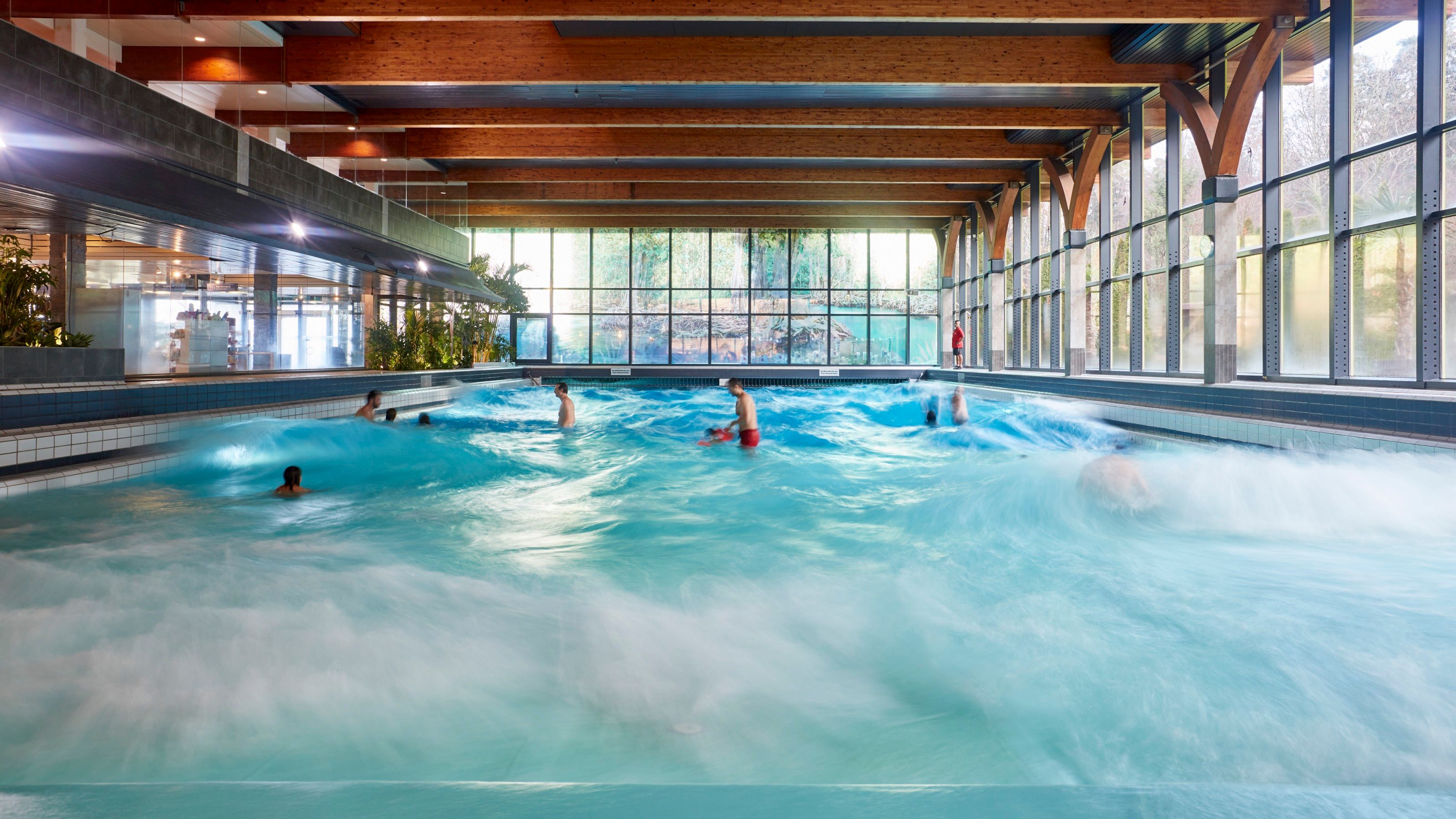 Water park Alpamare with visitors swimming in the wave pool