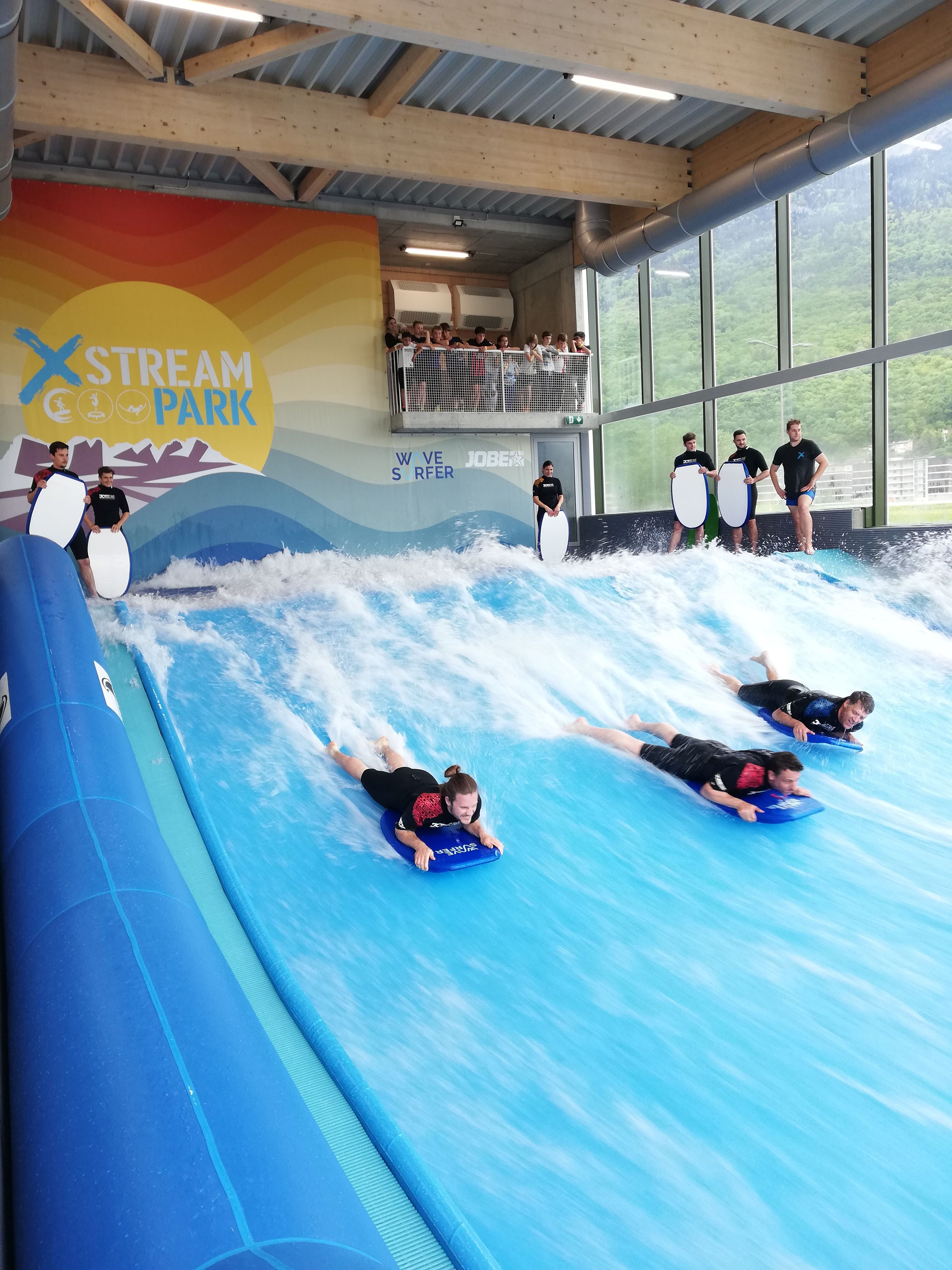 Bodyboarding at Xstream Park: Fun surfing on indoor waves, perfect activity for groups.