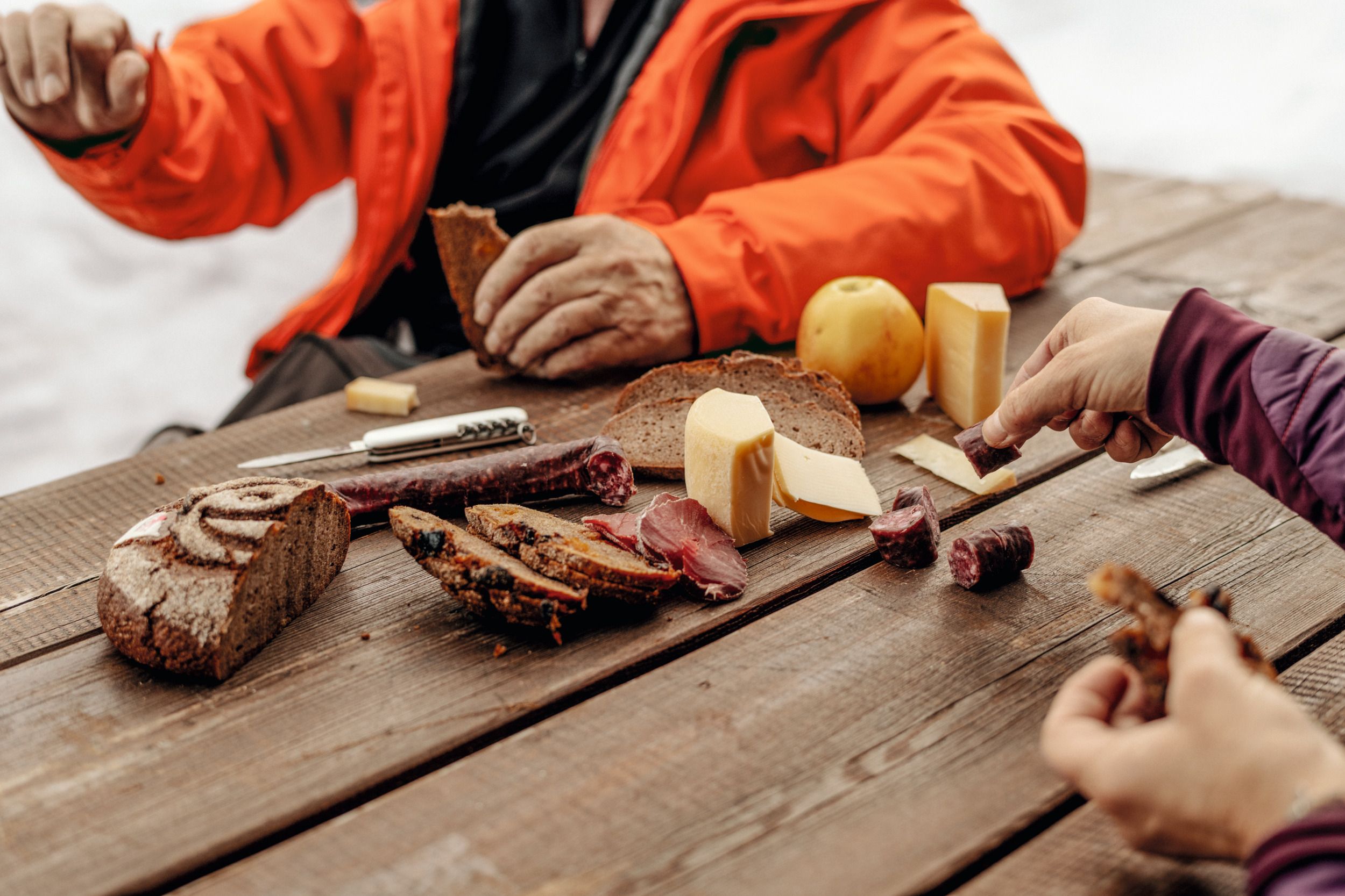 Swiss cheese: Enjoy delicious cheese and sausage with friends during a picnic in the mountains.