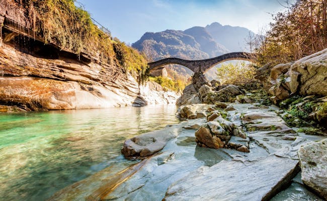Bridge Lavertezzo: picturesque landscape by the river with nature and mountains in summer.