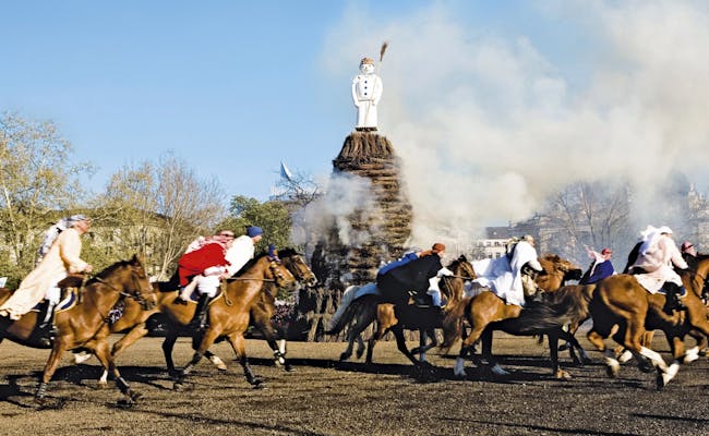 Sechseläuten Zurich festive riders with horses around the bonfire