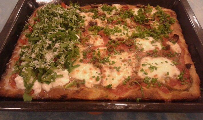 Sicilian pizza with fresh salad, fresh vegetables, and cheese.