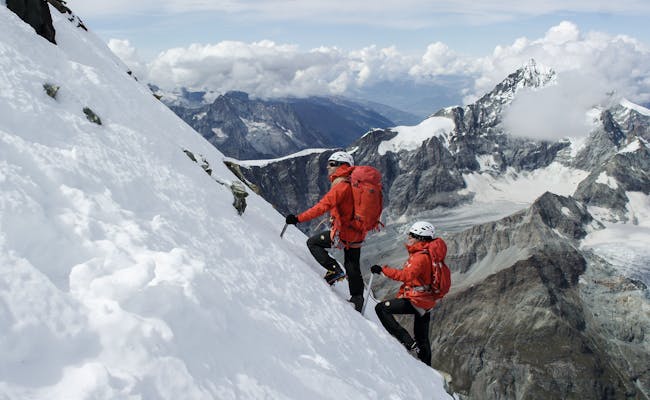 Breithorn: climber in red, snow, Zermatt, exciting winter ascent.