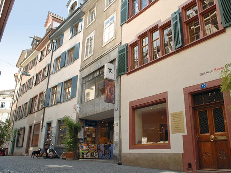 City tour Basel, old town with historic buildings and narrow streets.