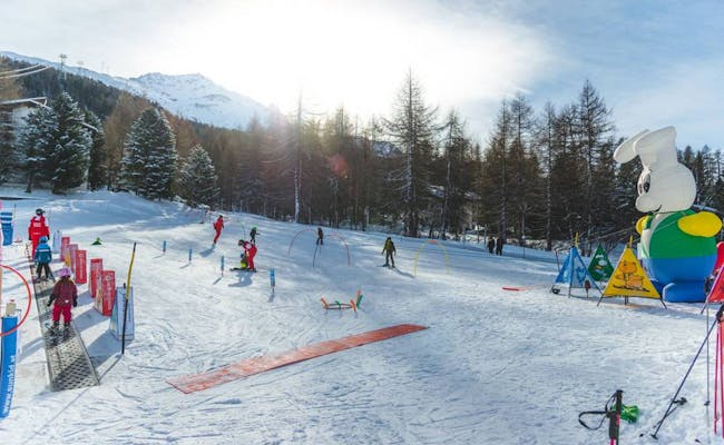 Ski Kinder Lift Corvatsch mit Kindern beim Skifahren in der winterlichen Umgebung.