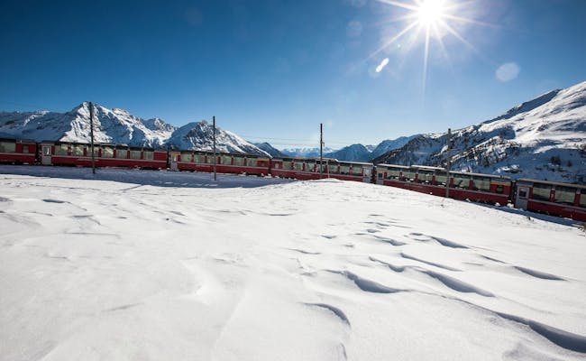 Bernina Express: pittoresk winterlandschap in het Engadin met besneeuwde bergen en trein.
