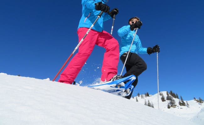 Snowshoe hiking at Trübsee with blue sky and snow
