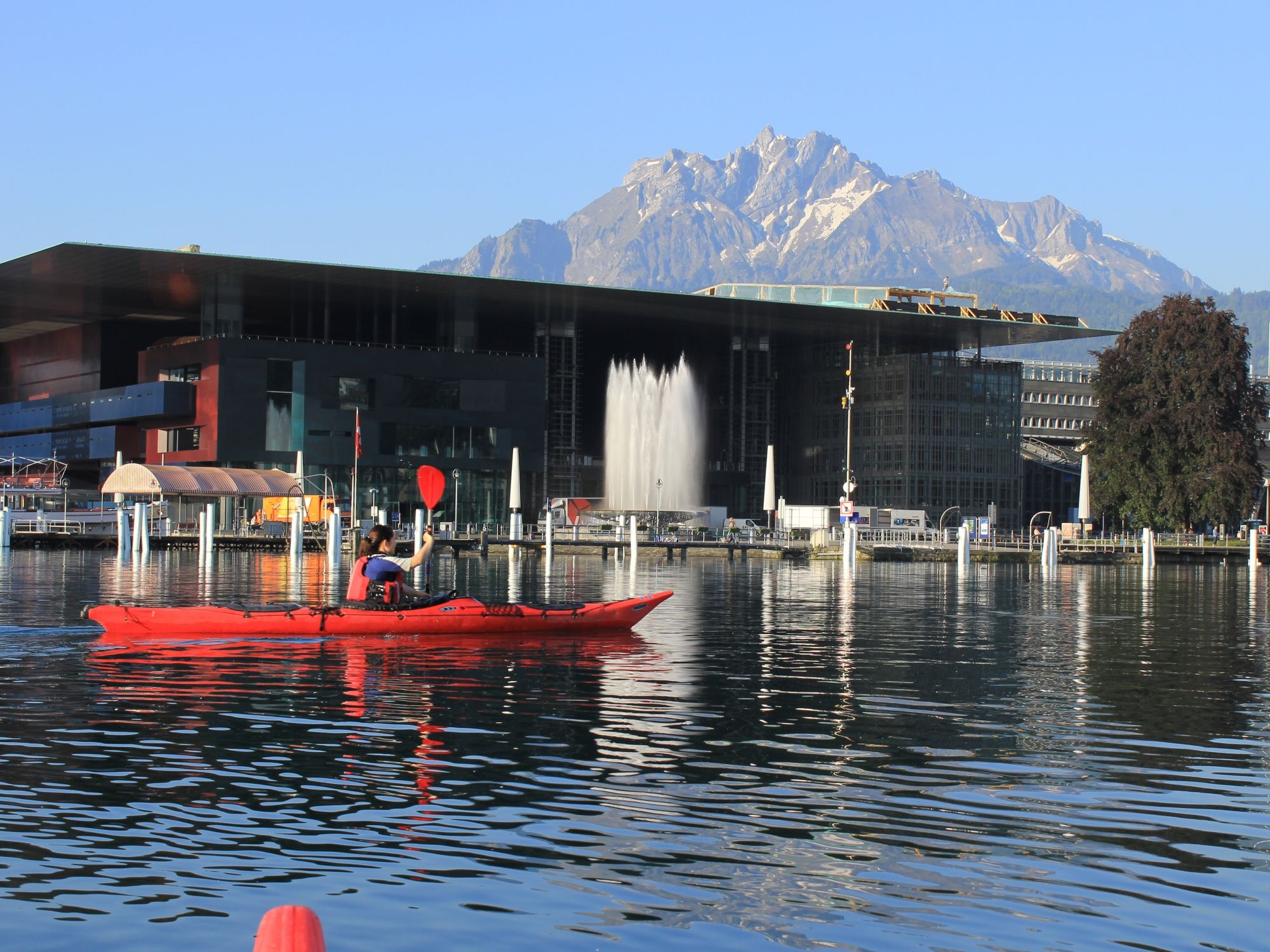 Sea Kayak Tour: Kayaks on Lake Lucerne with views of the Alps and Lucerne's architecture.