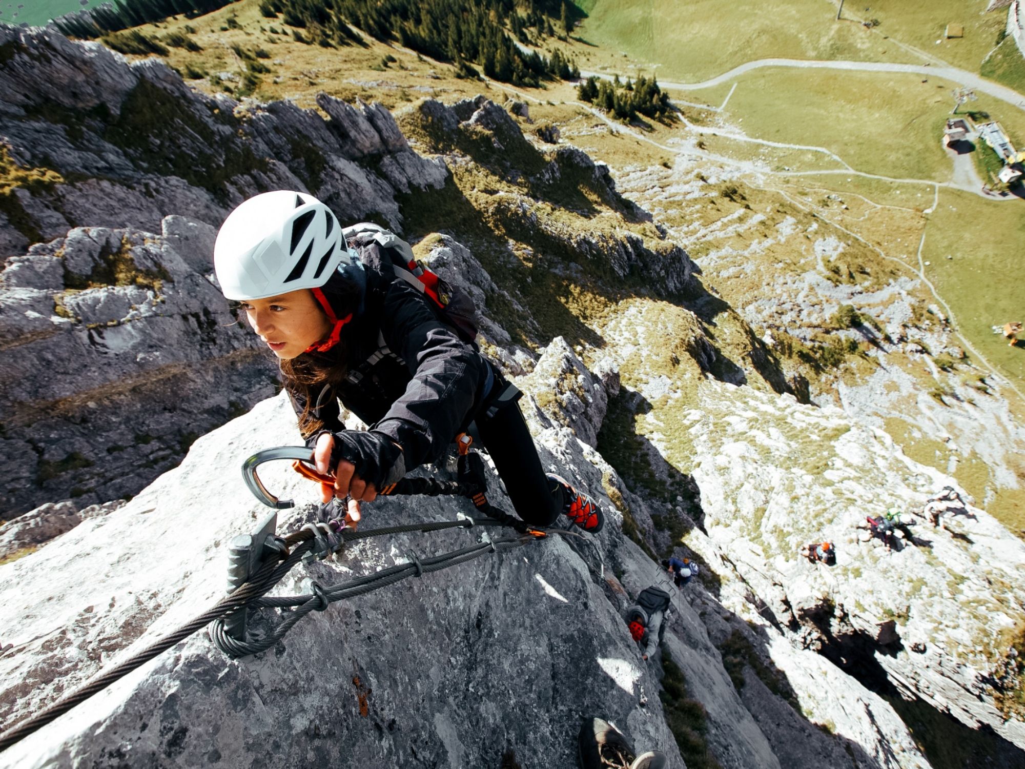 Via ferrata: Woman climbing, impressive rock formation, rent via ferrata set.