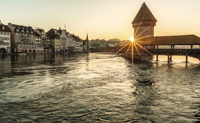Chapel Bridge in Lucerne: impressive city view with water and architecture, experience the summer mood.