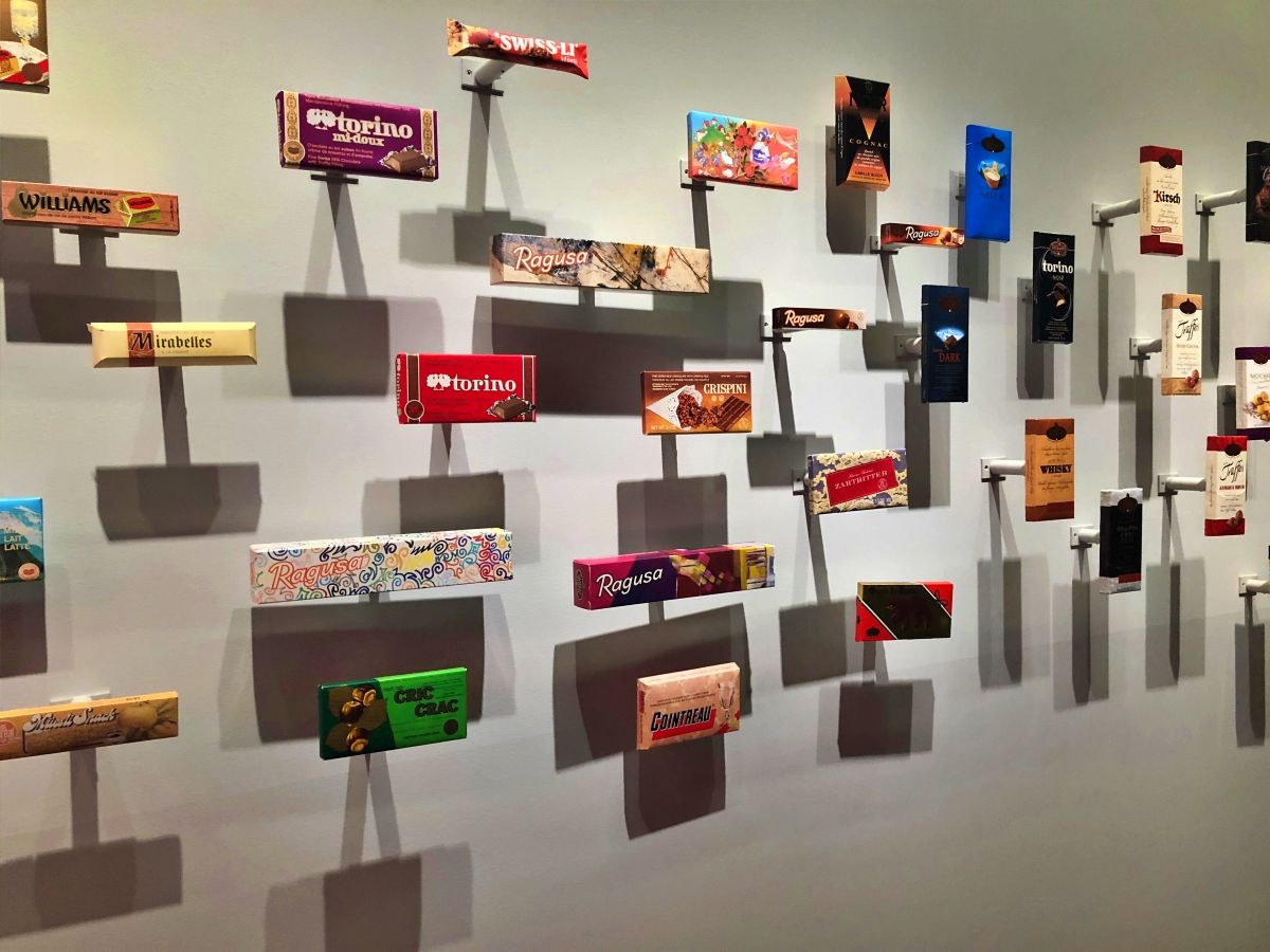 壁にいろいろな形のスイスチョコレートを展示しています。