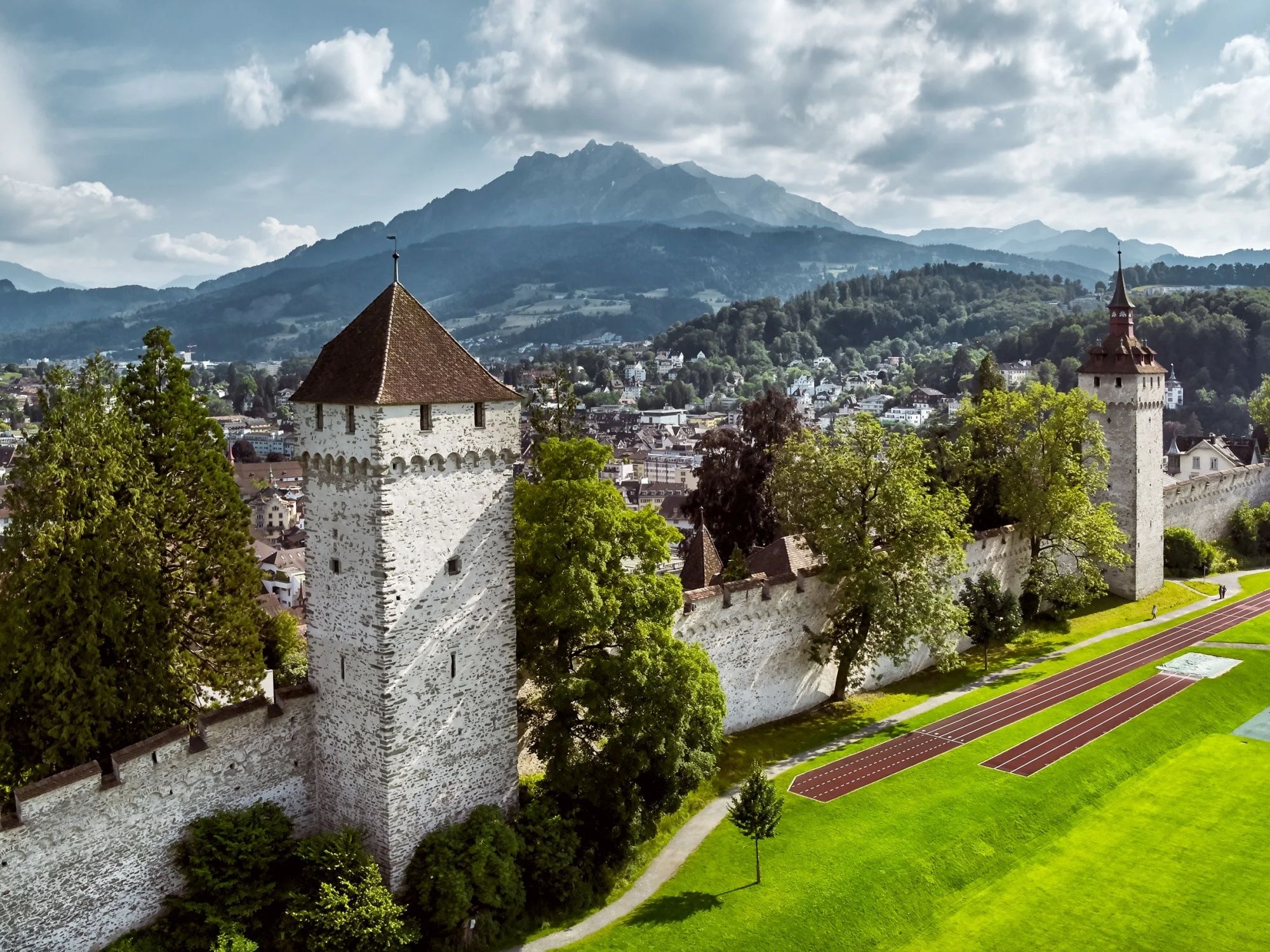 Musegg Wall in Lucerne with a view of the mountains and the city