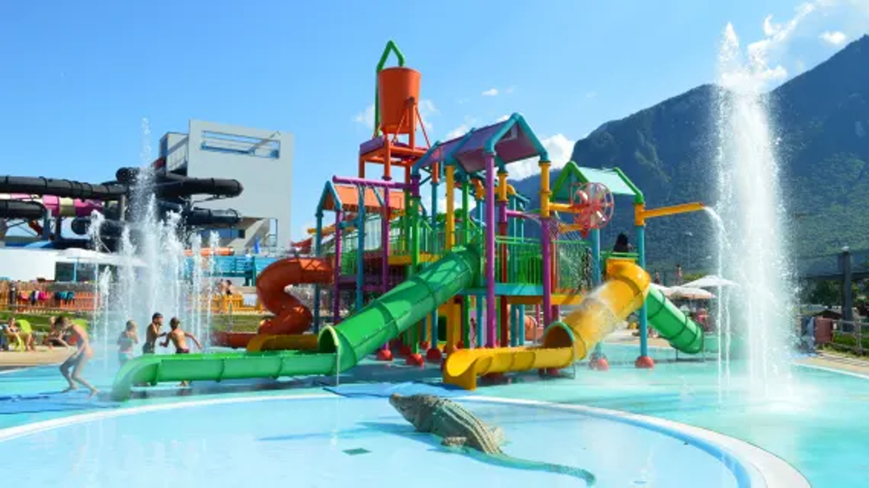 Water park Aquapark Le Bouveret with colorful slides, spray attractions, and children