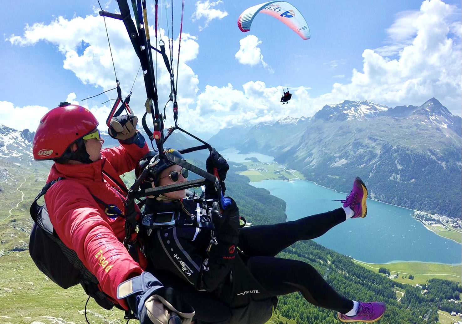 Tandem flight Engadin with paraglider over high mountains and lake