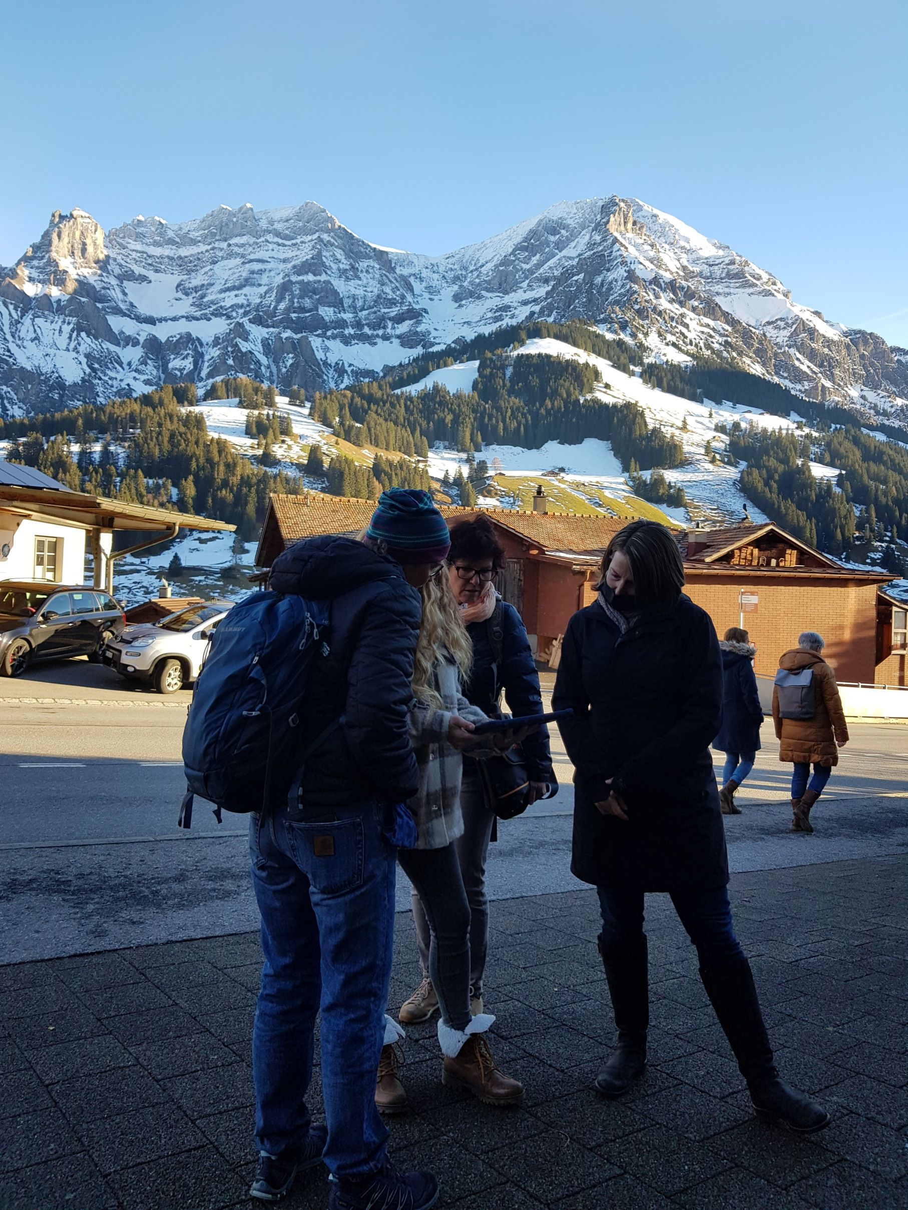 Permainan melarikan diri di Adelboden dengan pemandangan musim sejuk di kaki gunung dan kumpulan yang sedang bermain.