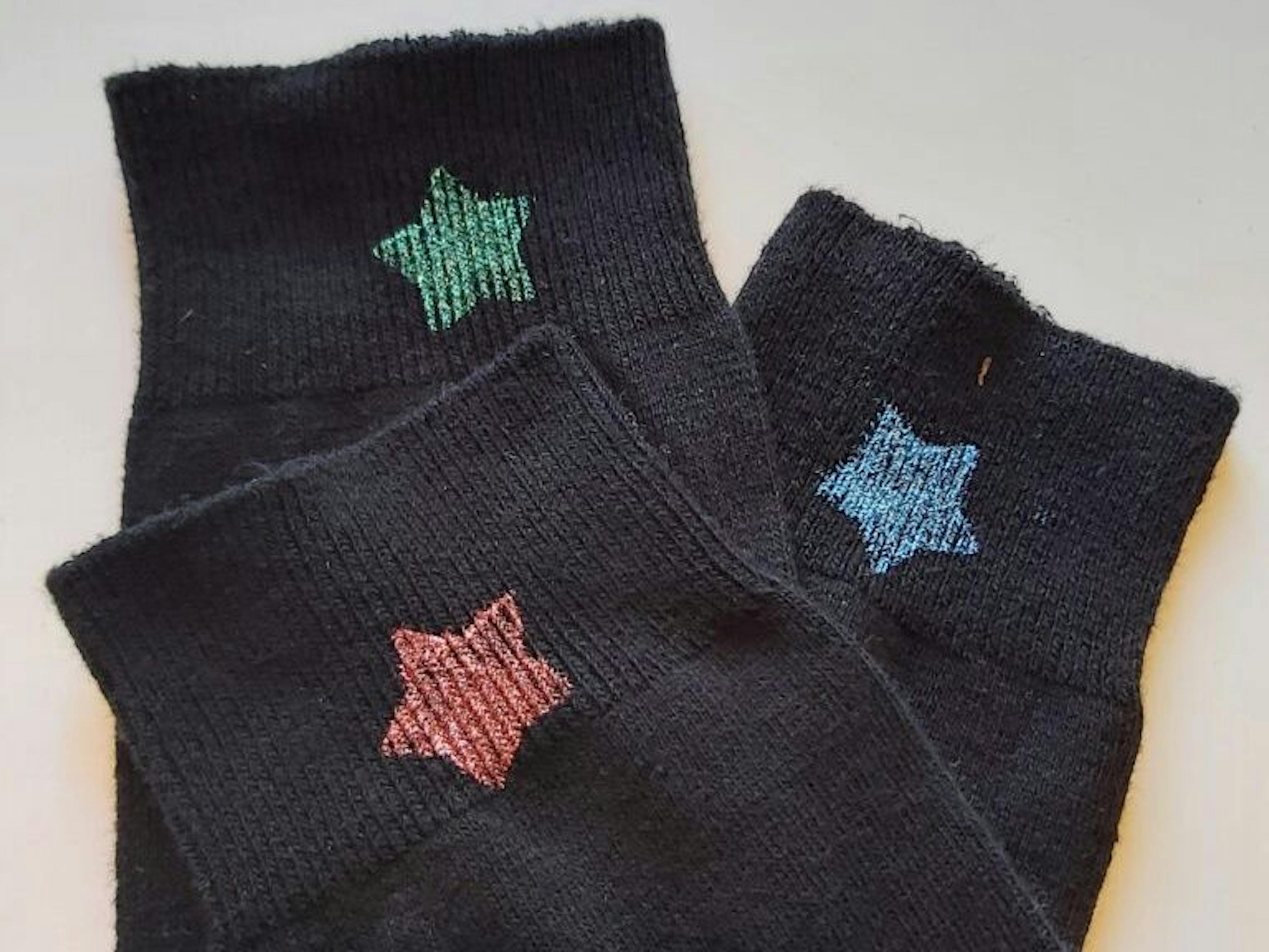 Black socks with colorful stars in three colors