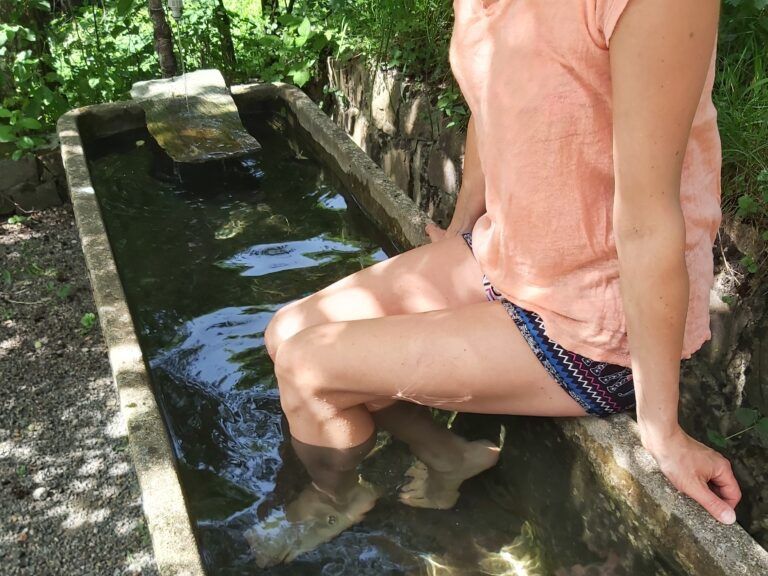 Woman sitting in the water basin and pouring concrete