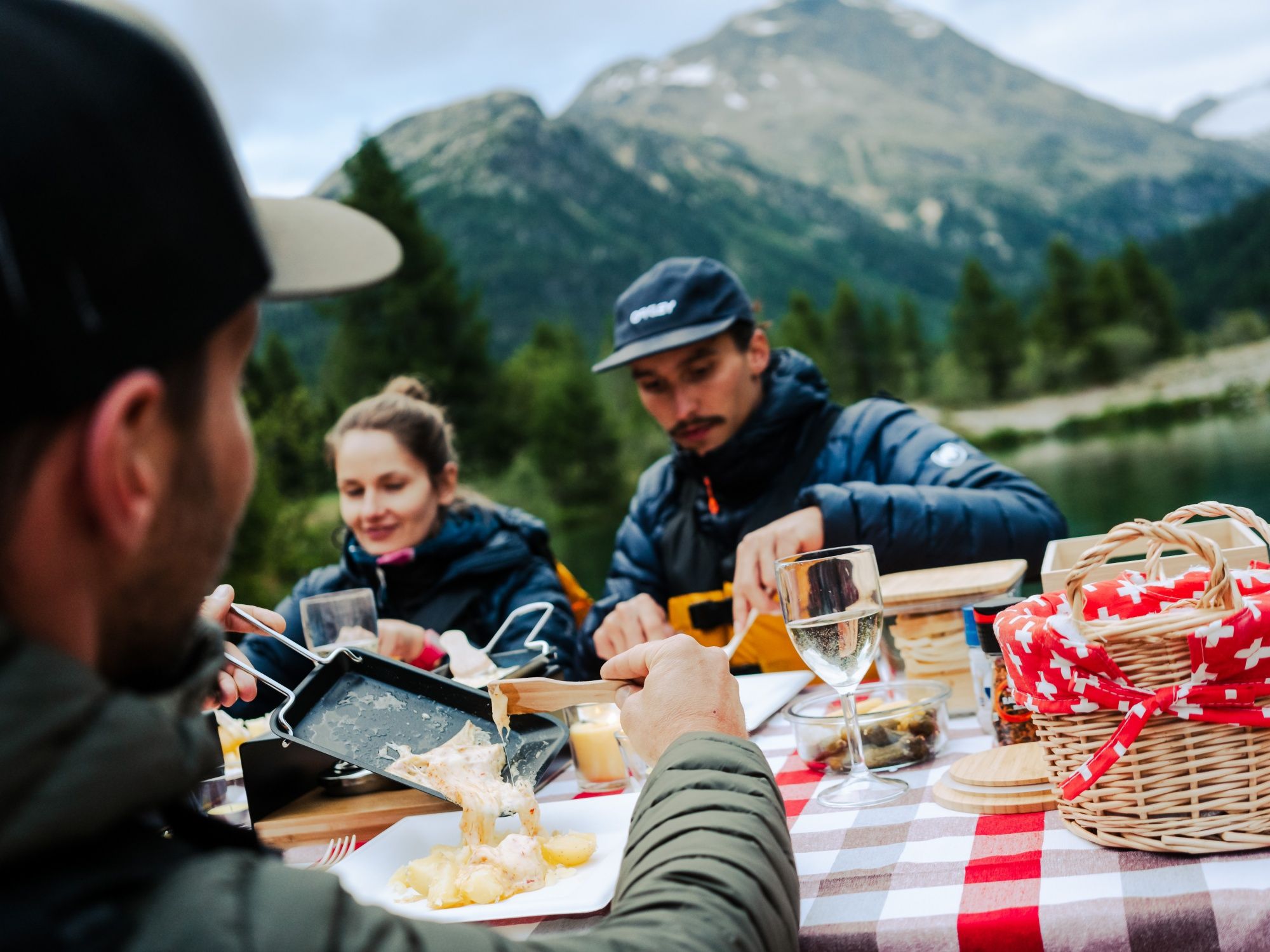 Enjoying raclette by the lake with friends, perfect for summer activities in nature