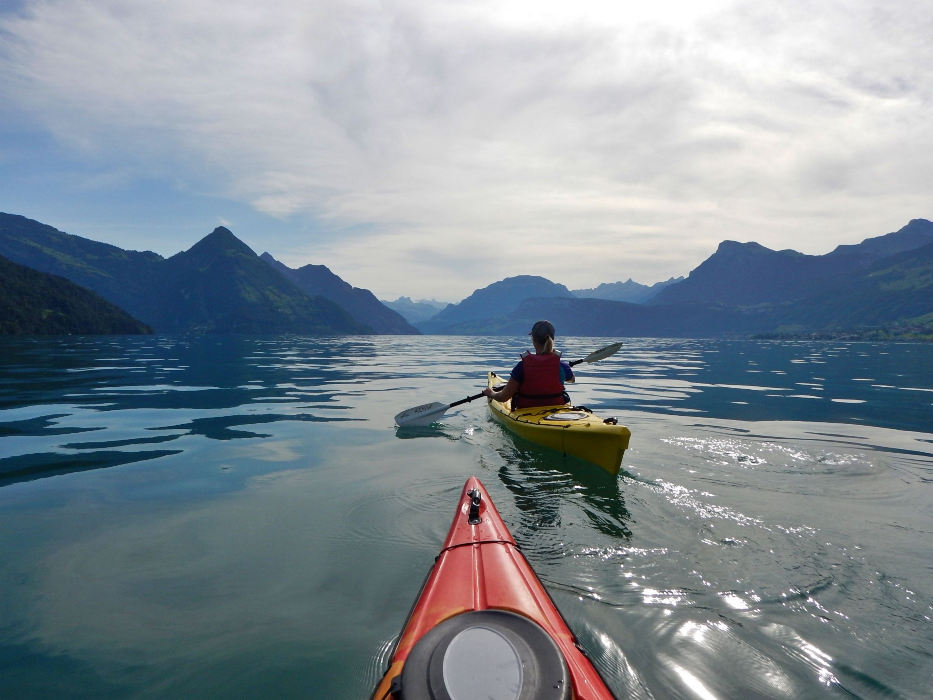 Sea kayaking on Lake Lucerne, surrounded by mountains, ideal for group and family outings.