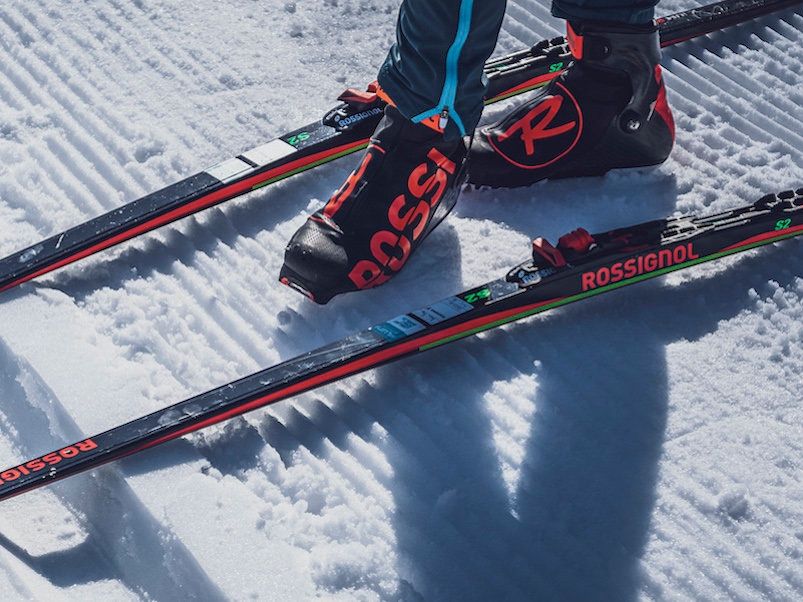 Evening cross-country skiing course in Davos with skis and boots in the snow.
