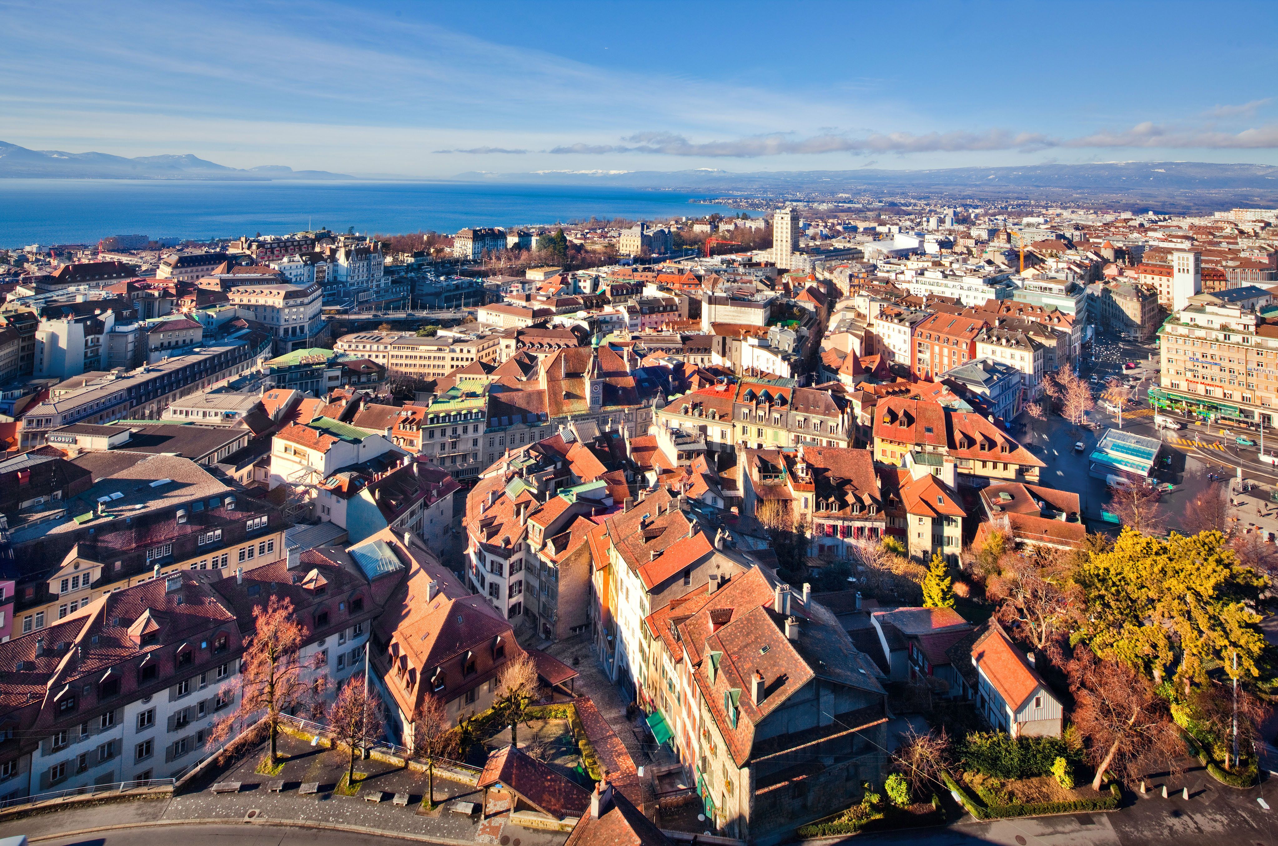 Cityscape of Lausanne with lake view, charming old town alleys, and impressive architecture.