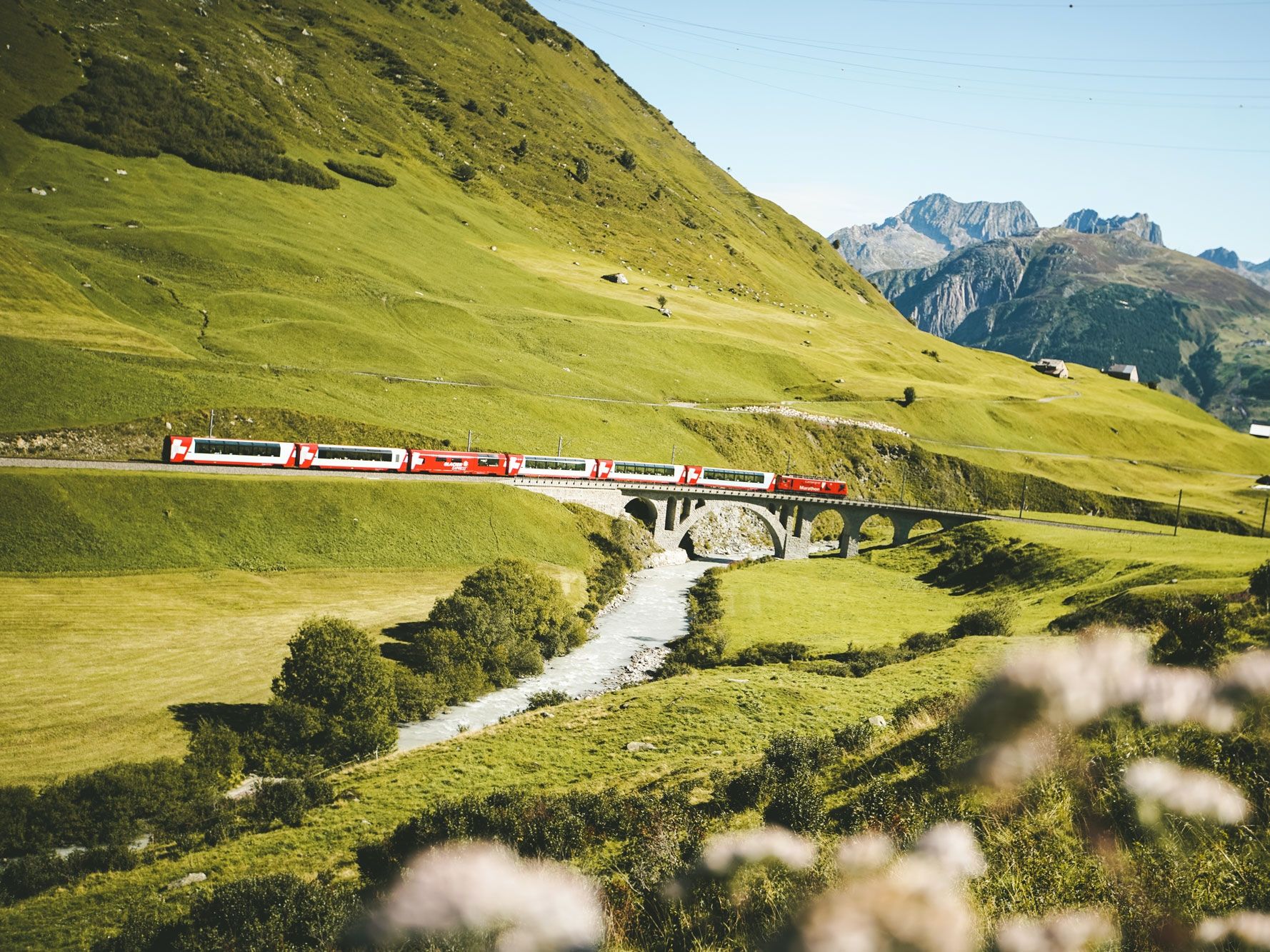 Glacier Express on the Oberalp Pass, picturesque landscape, train ride in Switzerland.