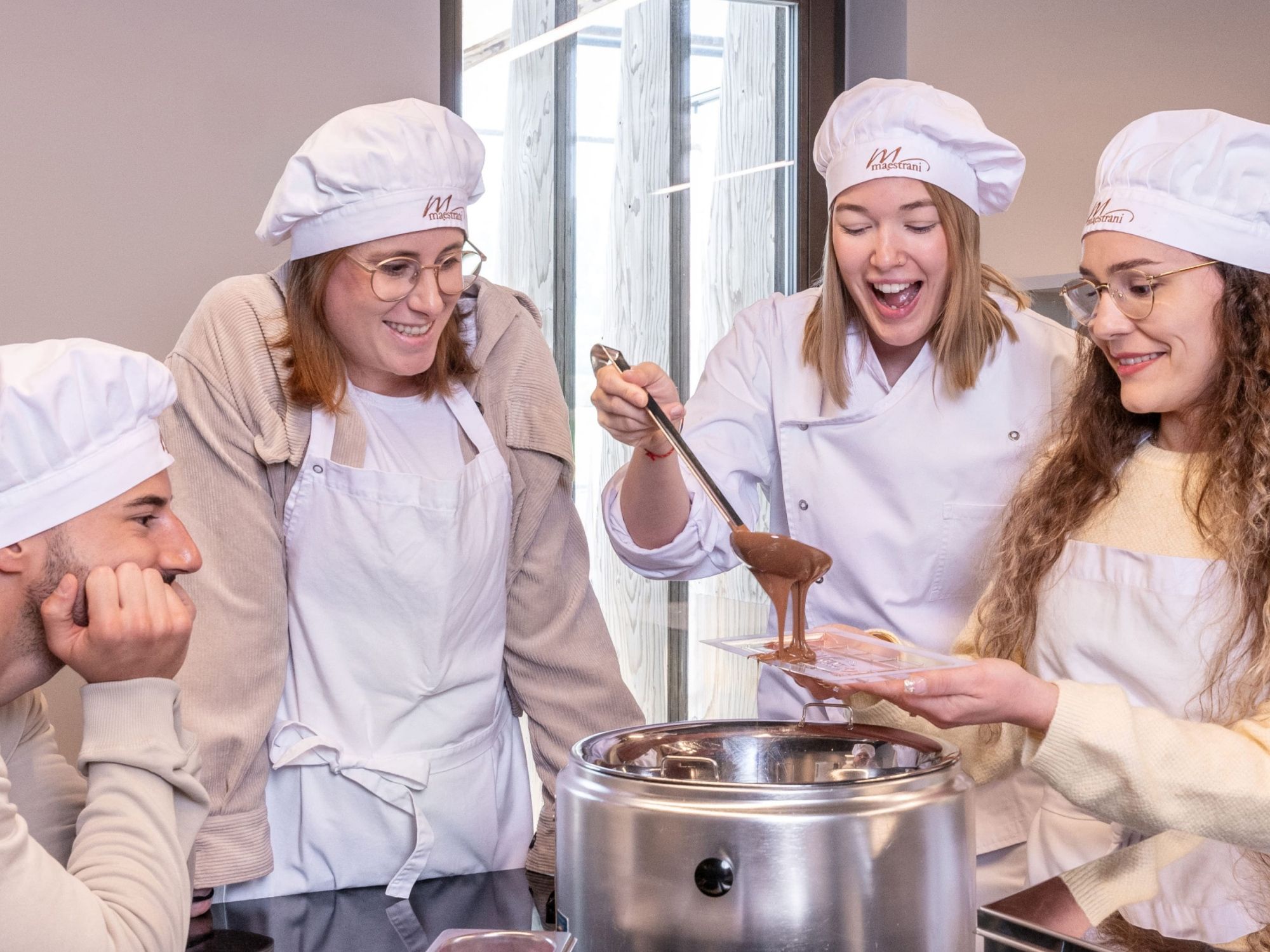 Casting course: Participants in the Chocolarium Maestrani during chocolate pouring.