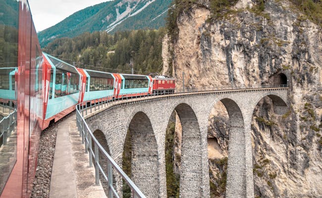 Glacier Express at the Landwasser Viaduct, impressive alpine landscape with train and rock formations.