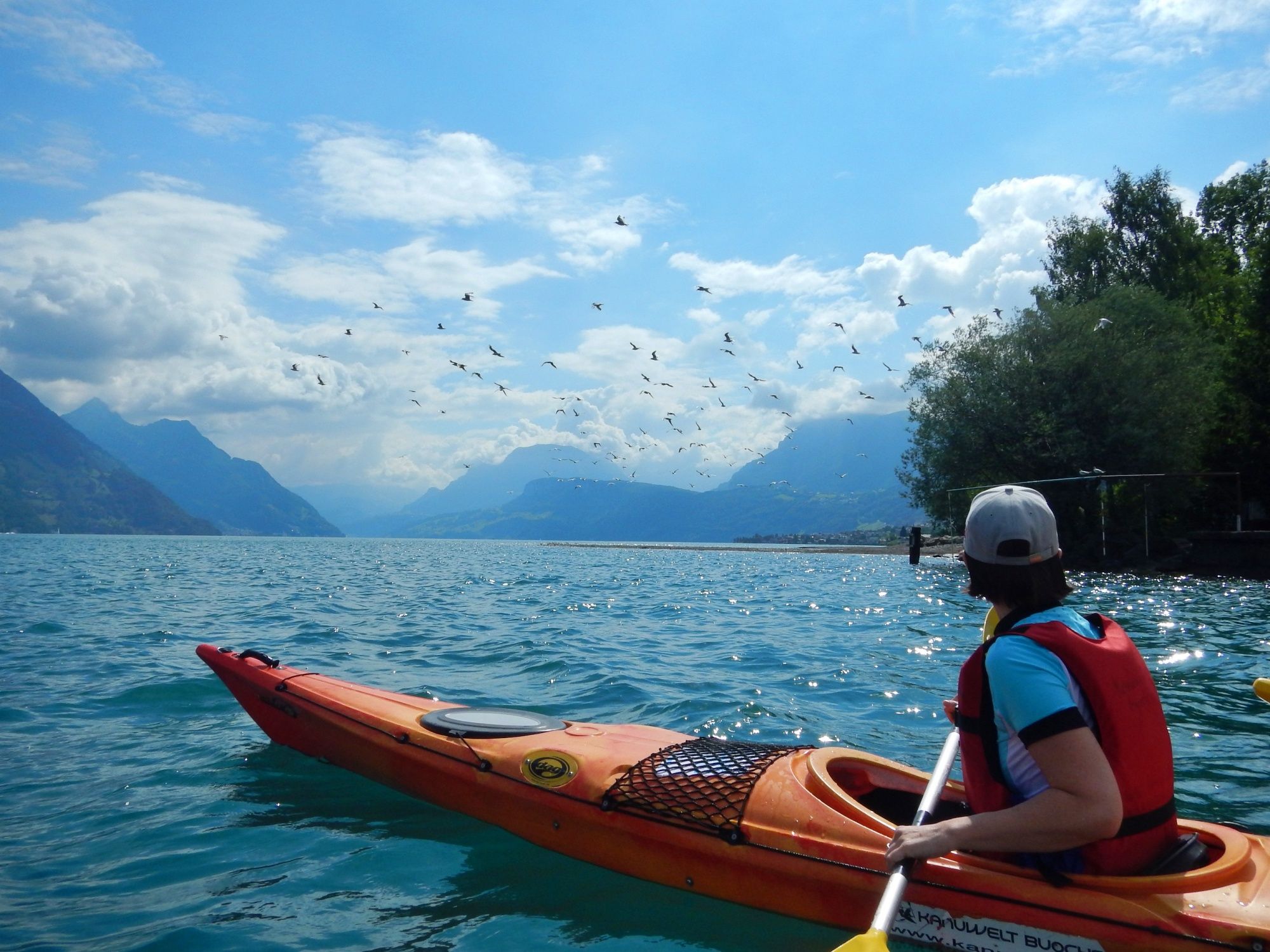 Sea kayaking on Lake Lucerne with an impressive view of the mountains and the sky.