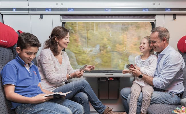 Familie reist mit Swiss Travel Pass im Zug und genießt die Aussicht.