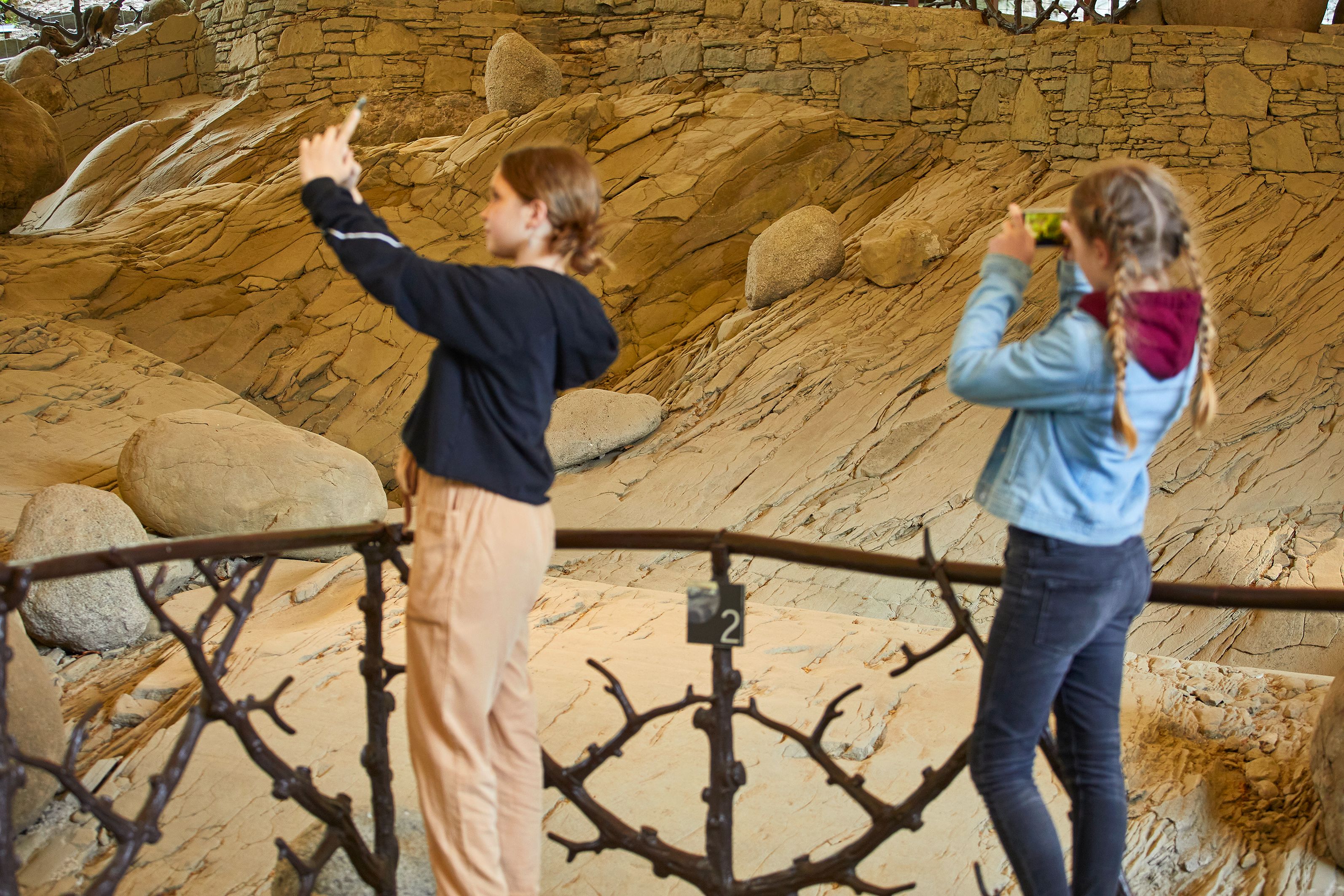 Kawah glasier: Dua gadis mengambil gambar ukiran glasier di taman glasier, keindahan alam yang mengagumkan.