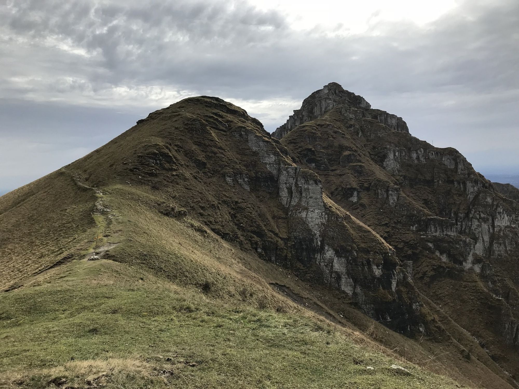 Monte Generoso: impressive mountain landscape with shades of green and a grey sky.
