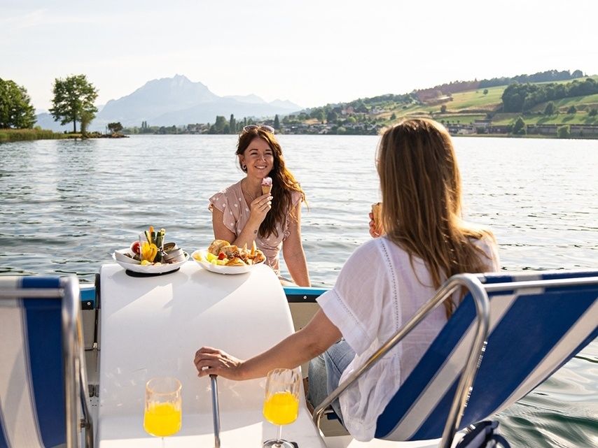 Boottocht op het meer met vrienden, lekker eten en genieten van de natuur in de zomer.