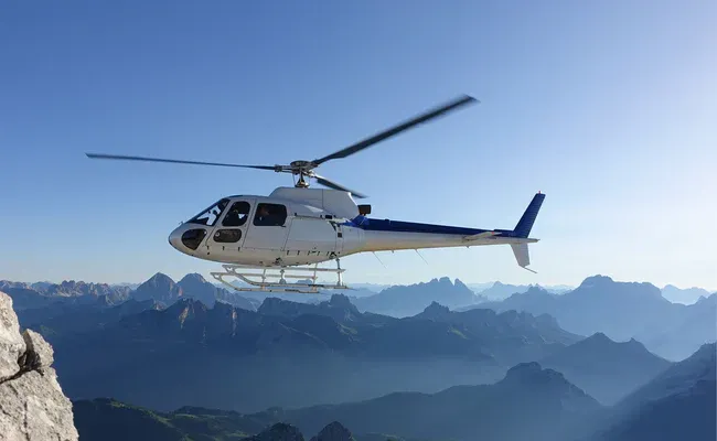 Helicopter on Alpine scenic flight over mountain landscape