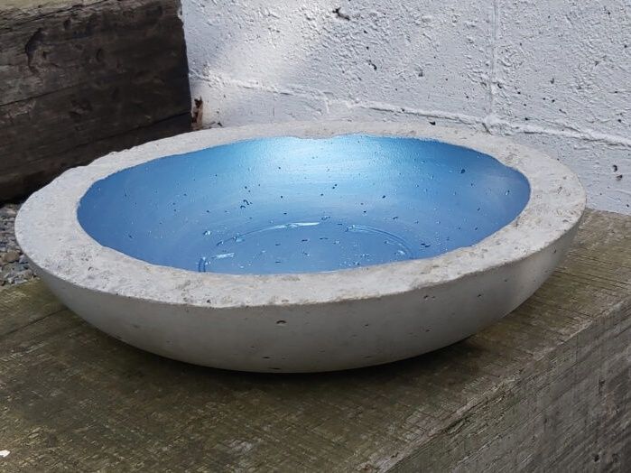 Casting concrete bowl with blue interior color on wood