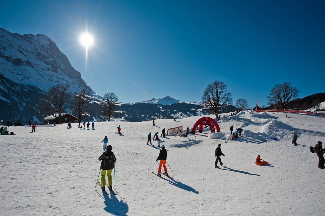 Bodmi Arena: Skiers in the snow, surrounded by awesome mountains and clear winter sun.
