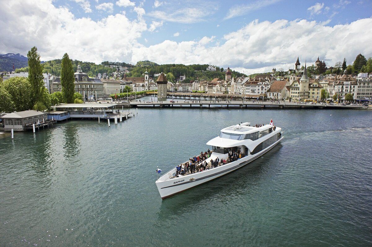 Boat trips on Lake Lucerne, Lucerne, in summer. Promenade with historic buildings.