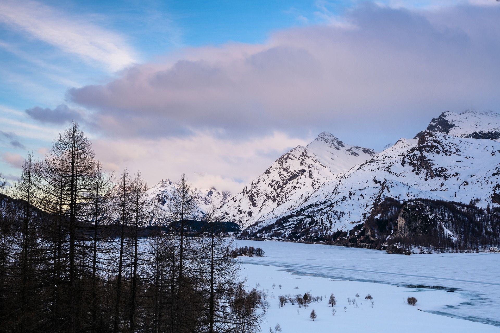 Vandring i Engadin vinter: fantastisk bergslandskap med snötäckta toppar och fruset sjö