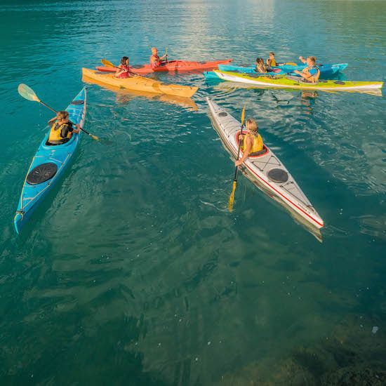 Kayak tour on Lake Brienz with participants in colorful kayaks.