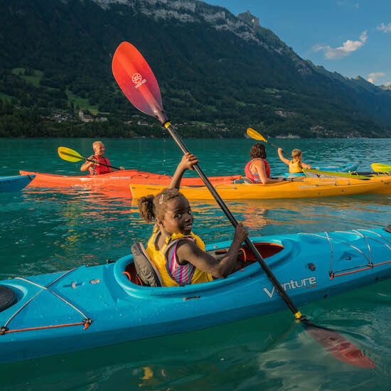 Kayaking on Lake Brienz. Families enjoy a sunny activity on the water.