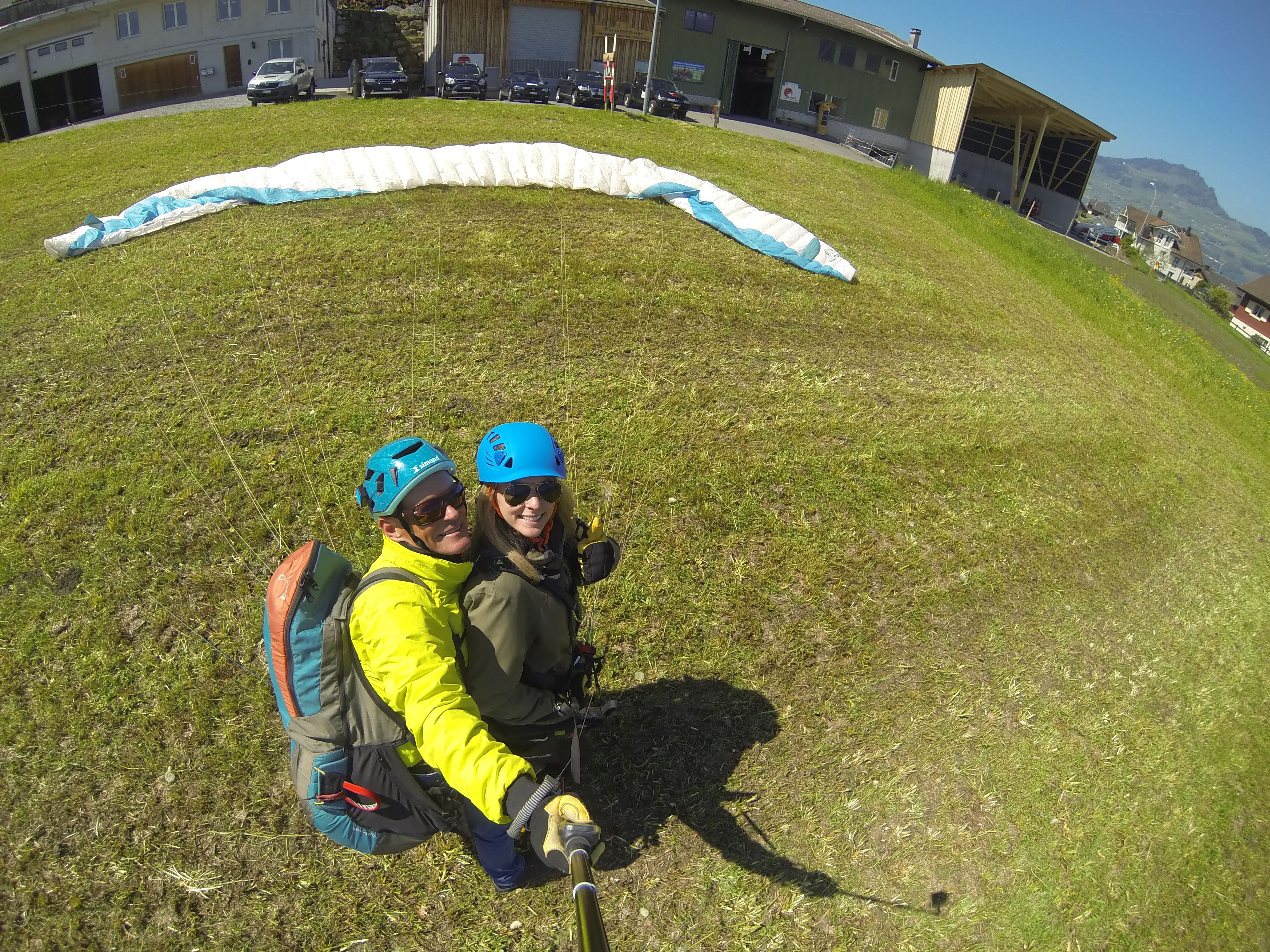 Tandem paragliding on Zugerberg with two pilots outdoors.