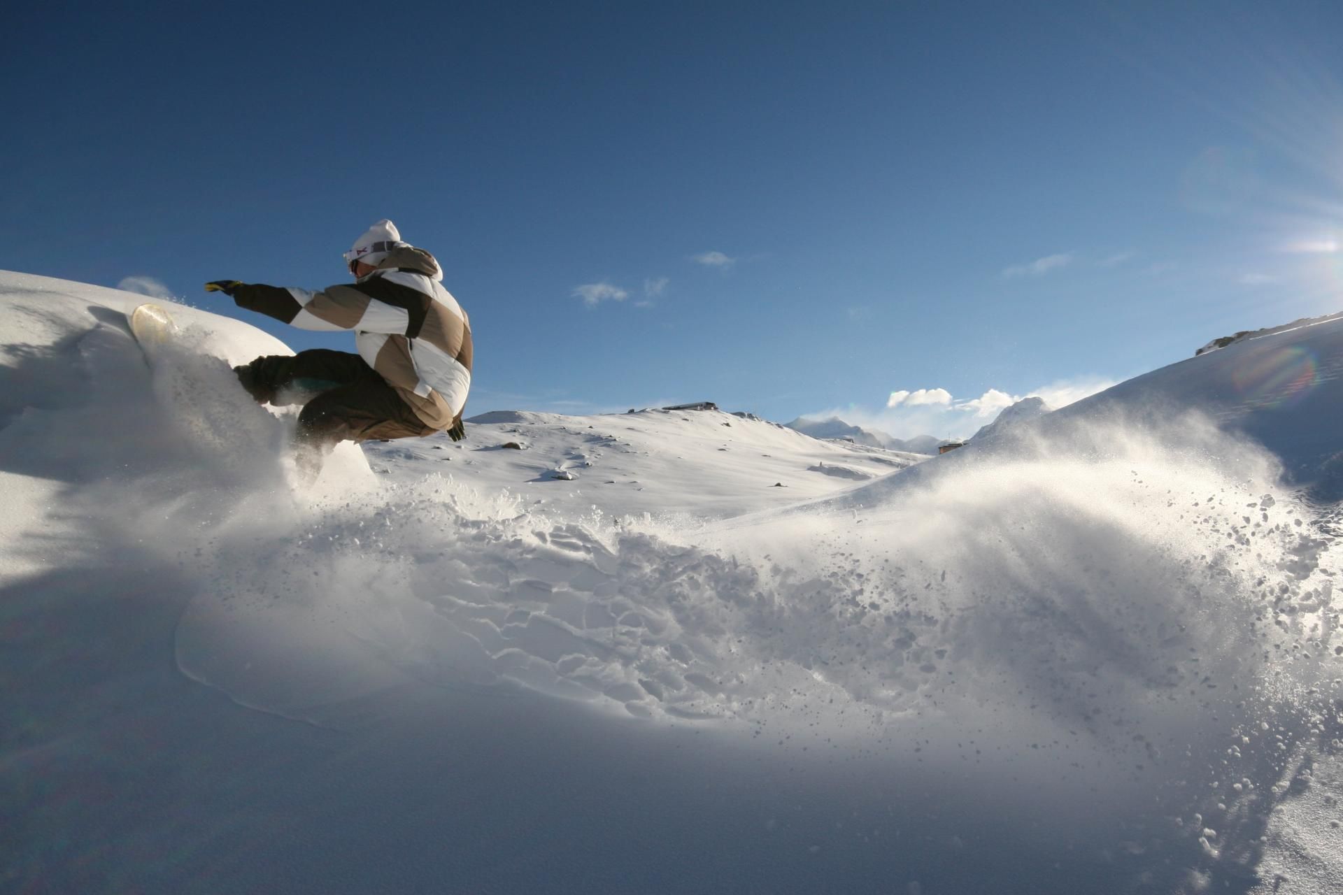 Snowboard Freeride di salju dalam pemandangan musim dingin dengan gunung bersalju.
