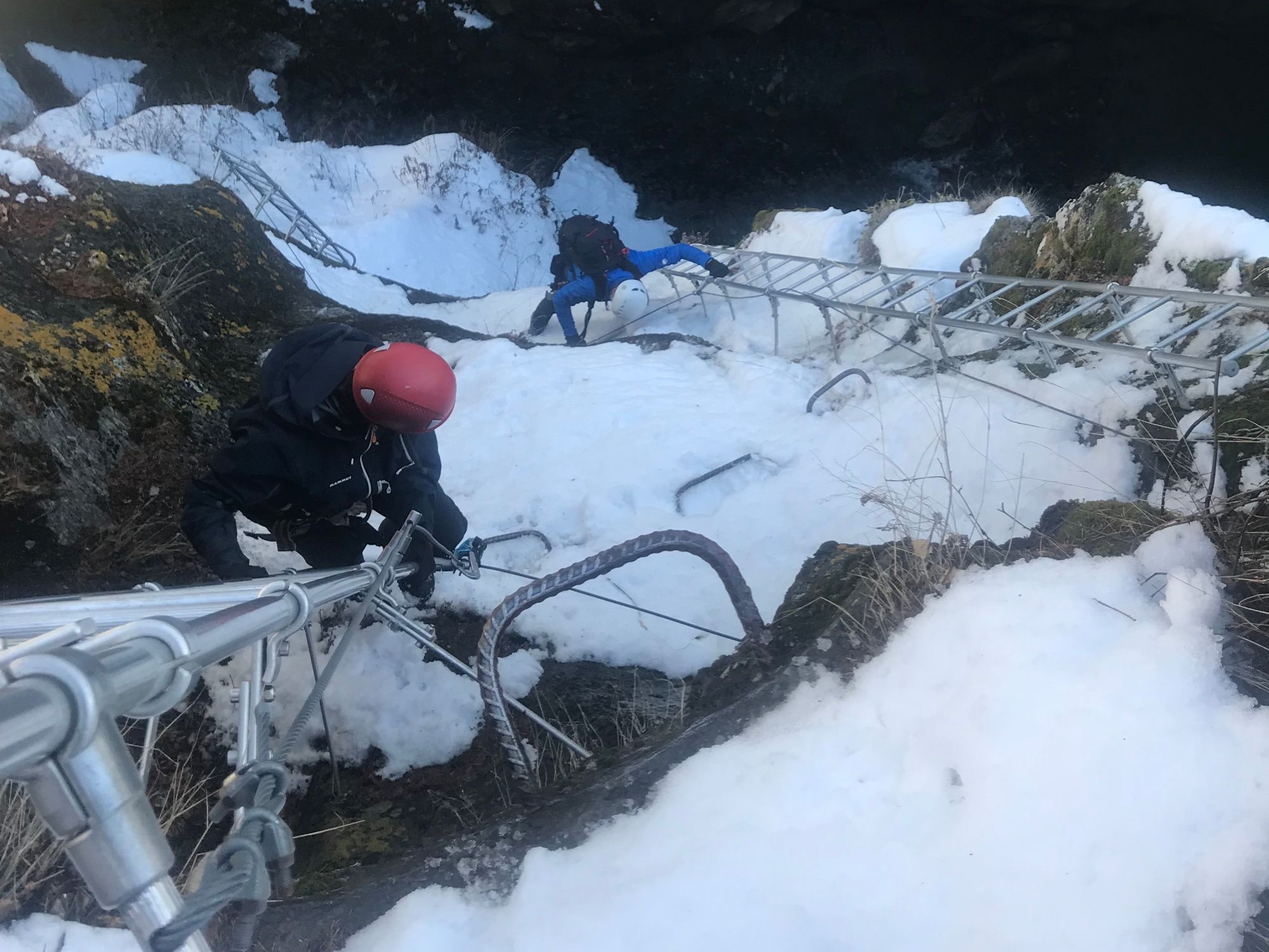 Winter Via Ferrata: Experience the thrilling ascent in the snowy mountains with friends.