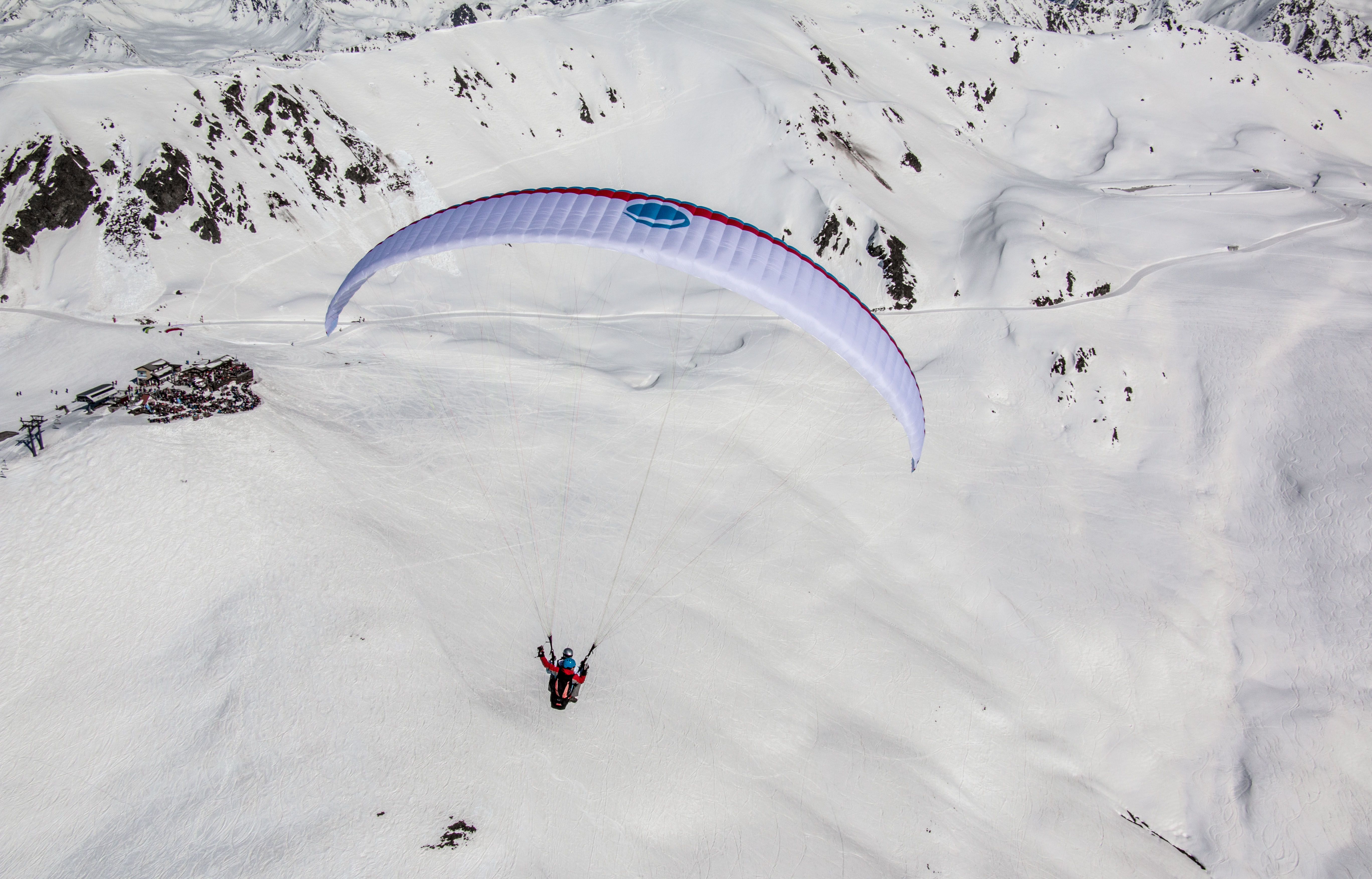 Paragliding v Davosu v zimě s zasněženými horami.