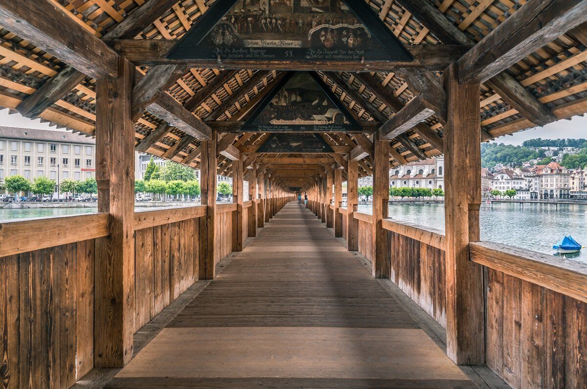 Chapel Bridge Lucerne with wooden structure and image elements on the roof.