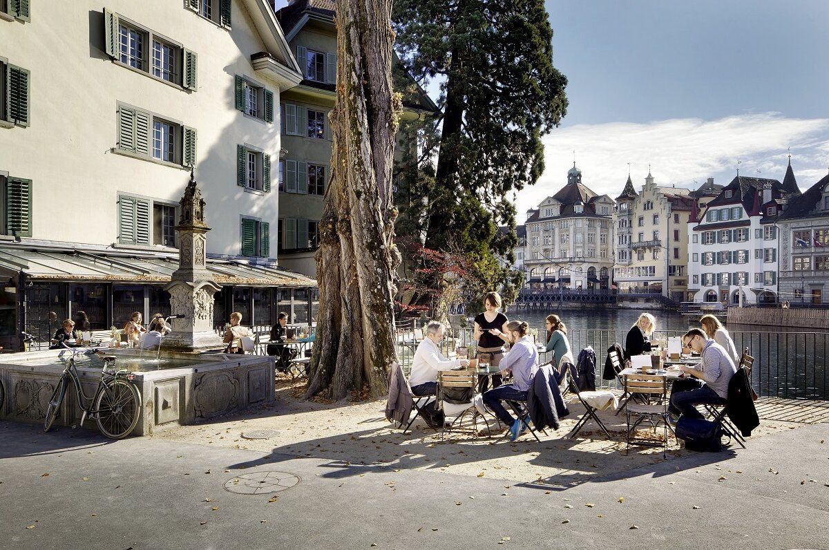 Lucerne day trip with cafés by the river, people enjoying the weather