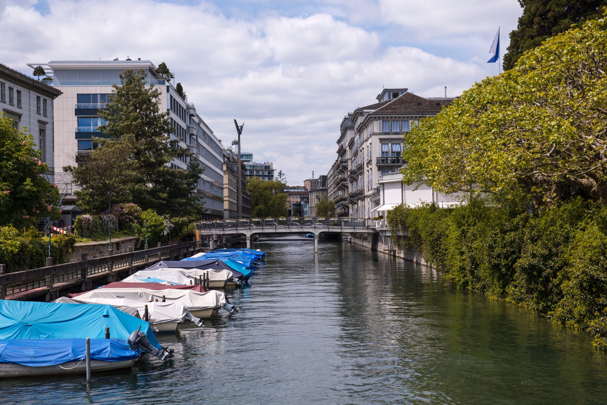 Schanzengraben: Beautiful water canal in Zurich with boats and green shore areas.