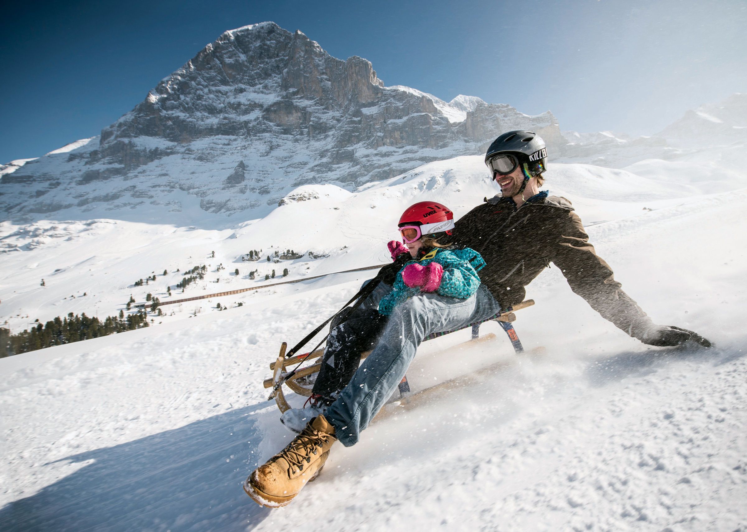 Sledding on the Eiger Run: Family enjoys winter fun in the Jungfrau Region.